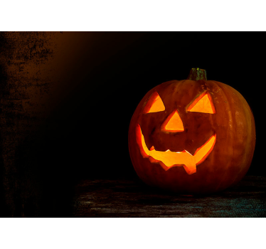 Tapisserie halloween citrouille sculptée qui brille - TenStickers